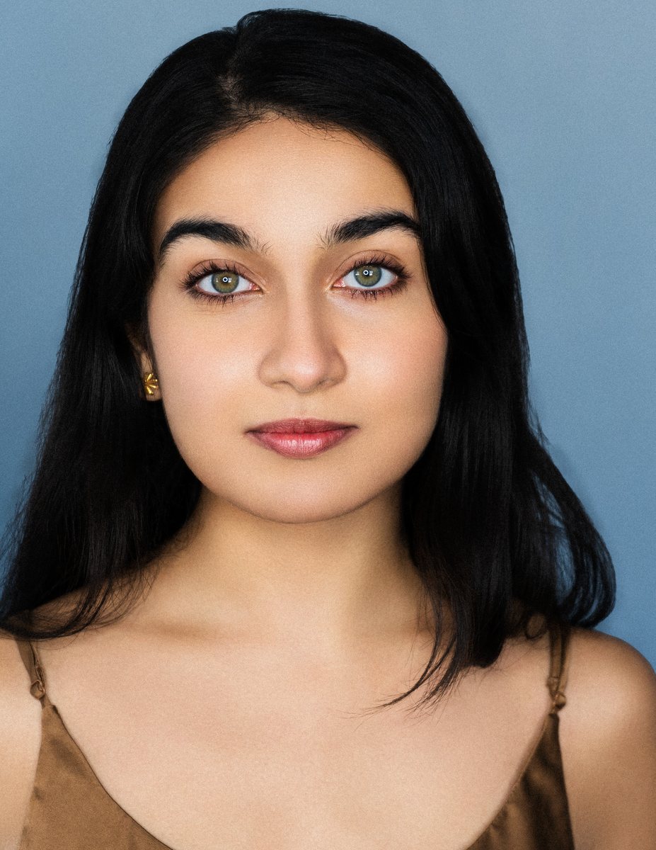 Actor headshot on a blue backdrop