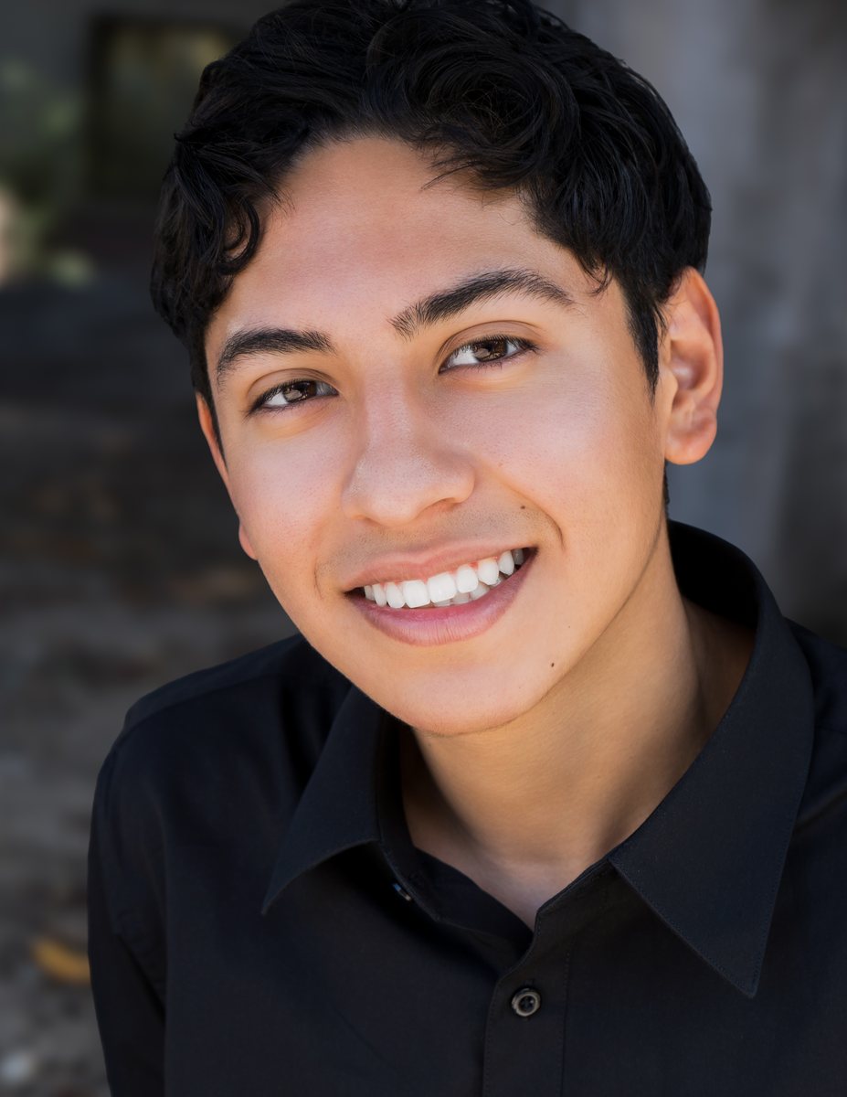 Actor headshot, young man smiling in a black shirt