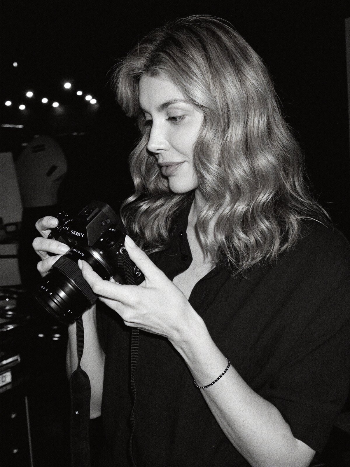 Marina Ziva, photographer, looking at her Sony camera
