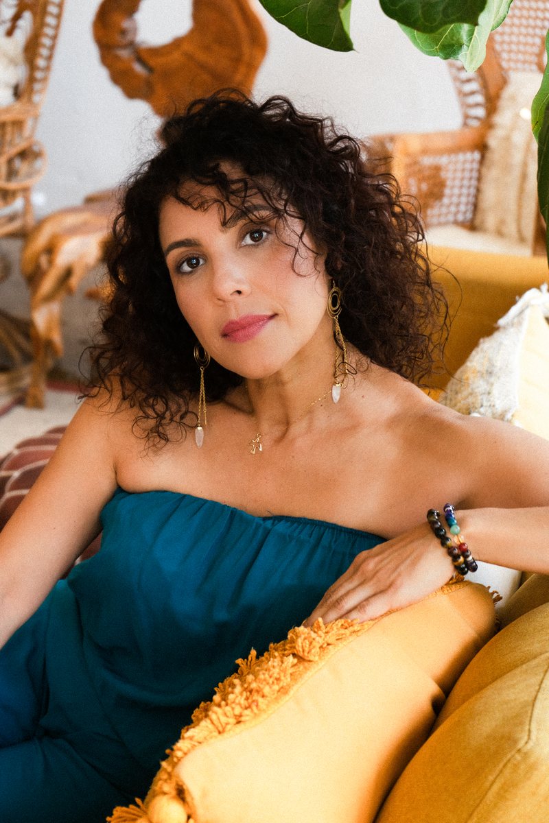 Lifestyle portrait, woman with curly hair in a teal top